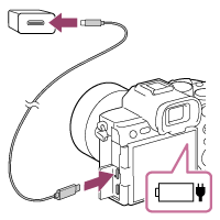 Illustration showing how to charge the battery pack by connecting the camera to a device compatible with USB Power Delivery using a commercially available USB Type-C cable