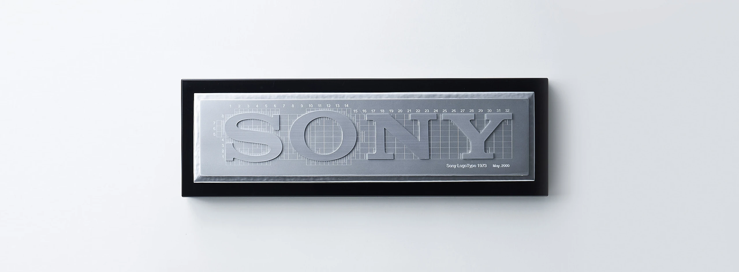 Plaque displaying the design grid for the Sony logotype, engraved &ldquo;Sony LogoType 1973, May. 2000.&rdquo;