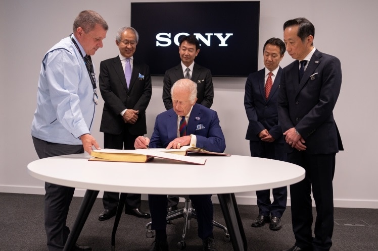 His Majesty King Charles III signing the Visitor's Book.