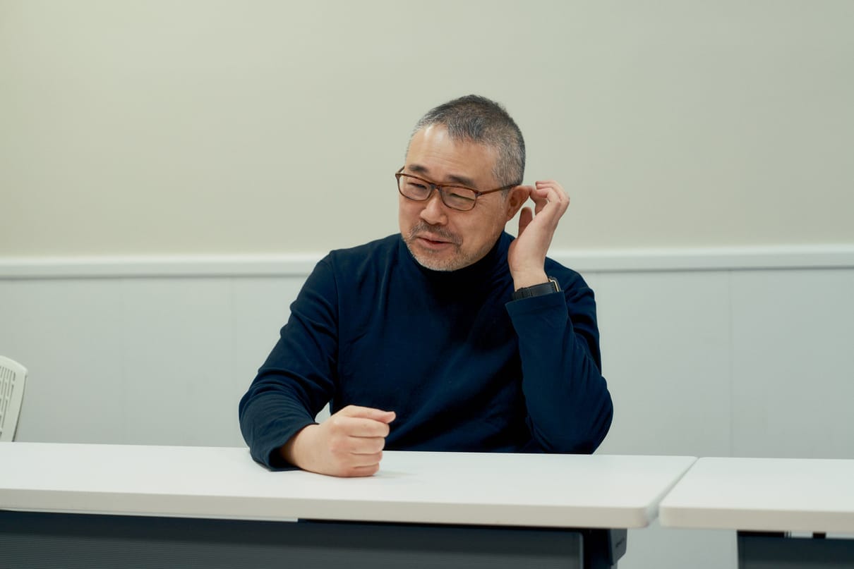 Director Ishihama giving an interview in the conference room