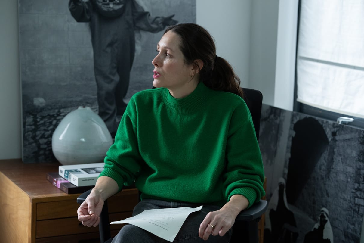 Alys Tomlinson sitting in a chair in her office, talking