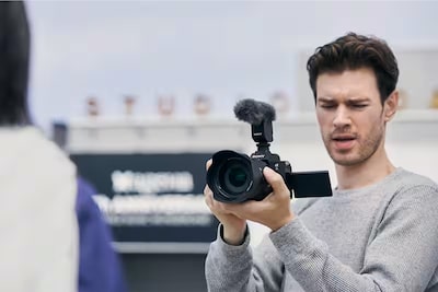 Videographer recording with a compatible Sony camera