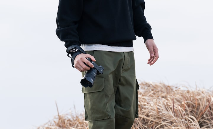 Image of man carrying camera in hand